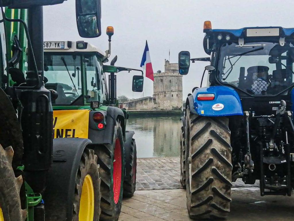 deux tracteurs sur le Vieux port, devant les tours de La Rochelle